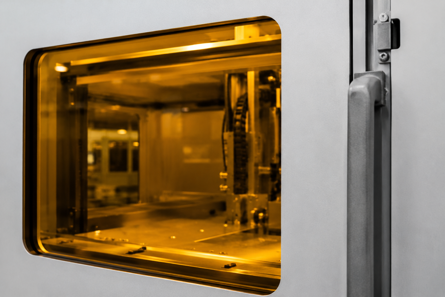 Close-up of an integrated laser safety viewing window installed in an industrial machine enclosure
